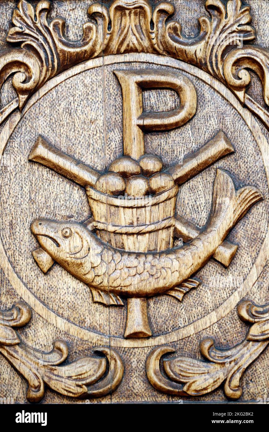 Carved wooden church door. Religious symbol. Pax symbol with fish Switzerland. Stock Photo