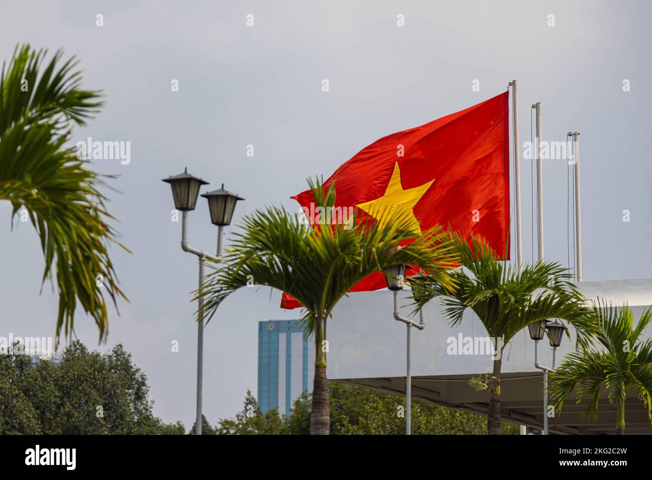 Ho Chi Minh City, Vietnam - November 07, 2022: Vietnamese national flag on the roof of the independence palace or reunification palace. The red flag w Stock Photo