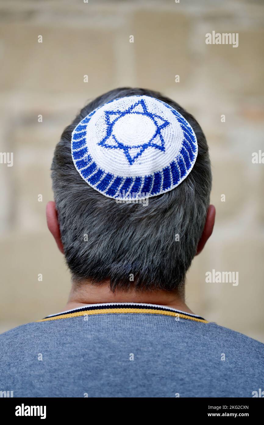 Back view of a man wearing a kippa which shows the star of David on the ...