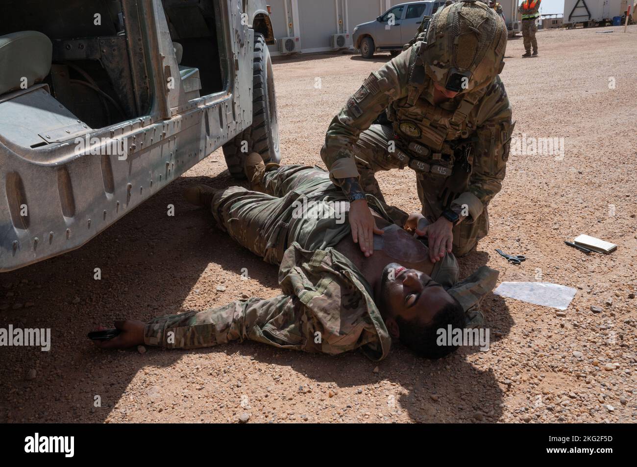 AIR BASE 201, Niger - U.S. Air Force Staff Sgt. Samantha Trappe, 409th Expeditionary Security Forces Squadron member, performs life-saving techniques on a simulated victim during an active shooter response exercise at Air Base 201, Niger, Oct. 25, 2022. These exercises allow our first responders as well as command and control elements to test their skills, training and any technology they utilize in this type of environment. Stock Photo