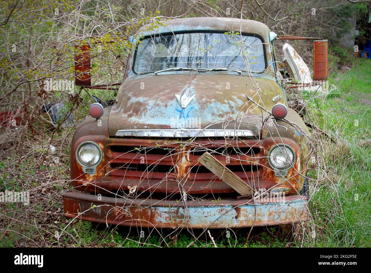 A broken abandoned rusty old truck left on a rural field Stock Photo ...