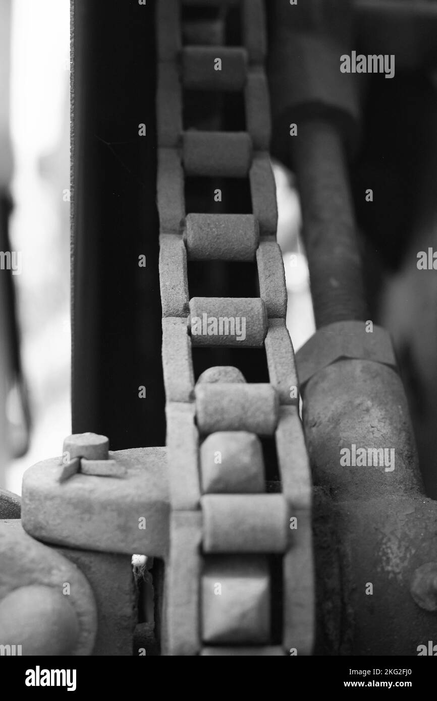 Vintage mechanical machine and engine with chains and gears in a black