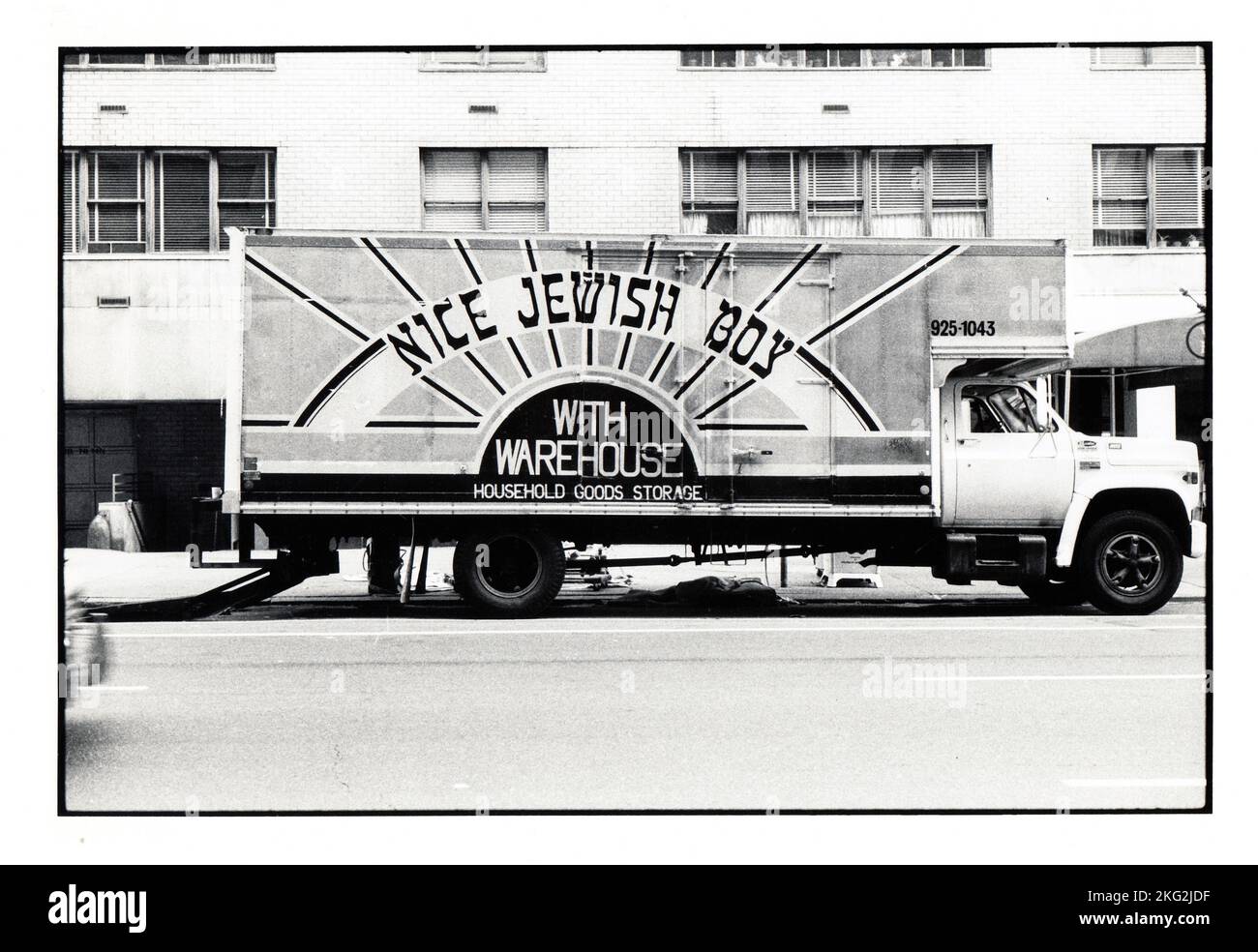 A truck for a moving business called Nice Jewish Boy With Warehouse, The font is meant to look like Hebrew letters. On the Upper West Side of Manhattan circa 1980. Stock Photo