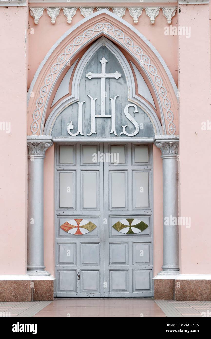 The JHS  monogram of the name of Jesus on a closerd church door. Danang. Vietnam. Stock Photo