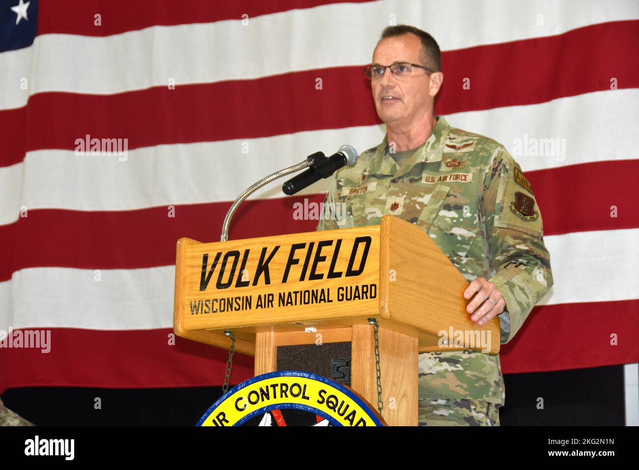 Maj. Shonn Breton, commander of the Wisconsin Air National Guard’s 128th Air Control Squadron, speaks during an Oct. 25 ceremony for returning Airmen of the squadron at Volk Field, Wis. Breton did not deploy with the Airmen, who represent approximately half of the squadron. The 128th deployed in support of air operations throughout the Middle East as attached members of the 727th Expeditionary Air Control Squadron. During the deployment they performed air surveillance, aircraft tracking, and overall command and control of tactical coalition aircraft operations throughout the Middle East in sup Stock Photo