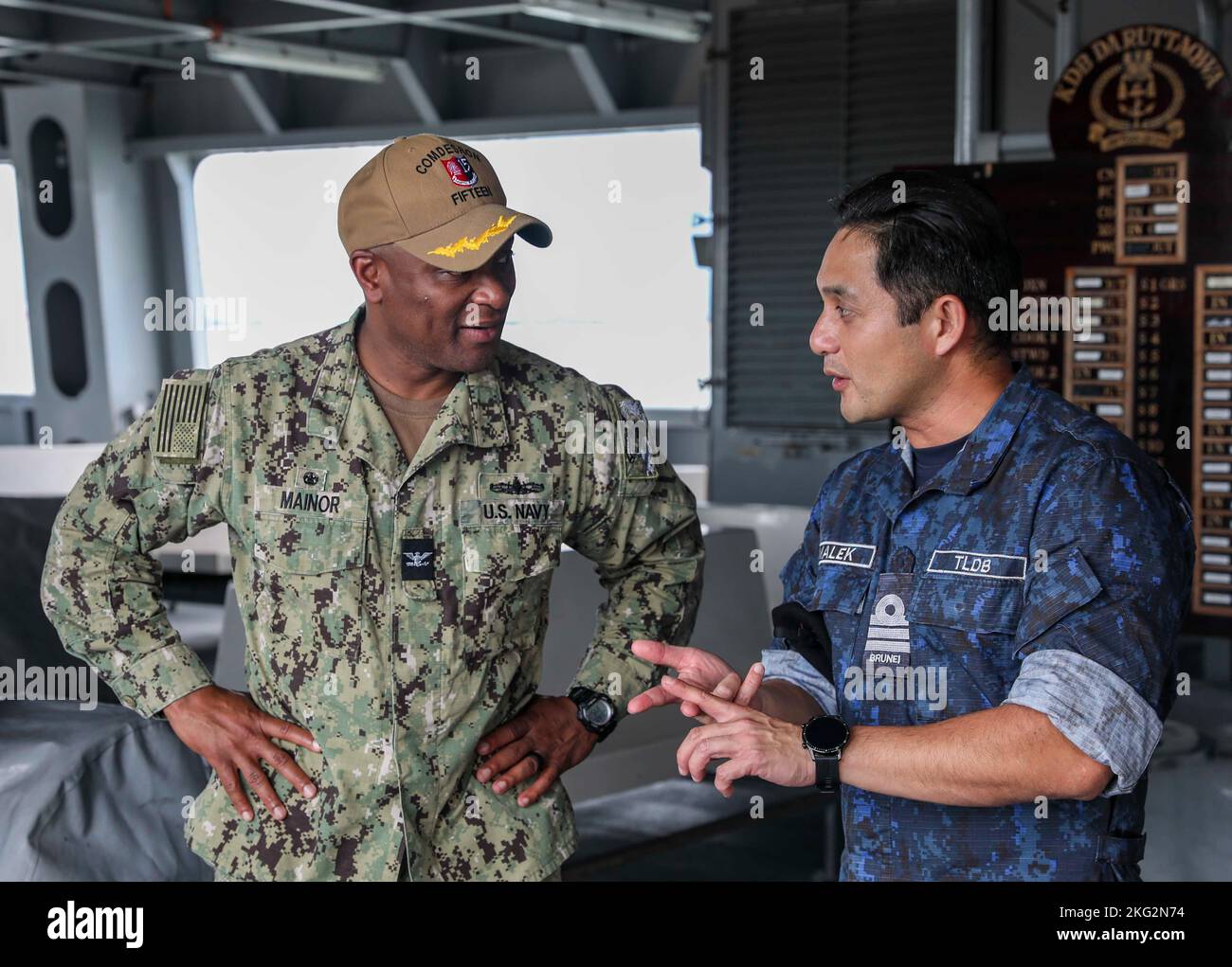 221025-N-FO714-1276  MUARA, Brunei (Oct. 25, 2022) Royal Brunei Navy Cmdr. Malek Fadillah bin Pehin Datu Juragan Laila Diraja Dato Seri Pahlawan Haji Kefli, commanding officer of Darussalam-class offshore patrol vessel KDB Daruttaqwa (DTQ 09), speaks with Capt. Walter Mainor, commander, Task Force 71, aboard the ship during Cooperation Afloat Readiness and Training (CARAT) Brunei, Oct. 25. CARAT Brunei 2022 highlights the 28th anniversary of CARAT among Allies and partners as a way to demonstrate long-term commitment to strengthening relationships throughout South and Southeast Asia and to hig Stock Photo