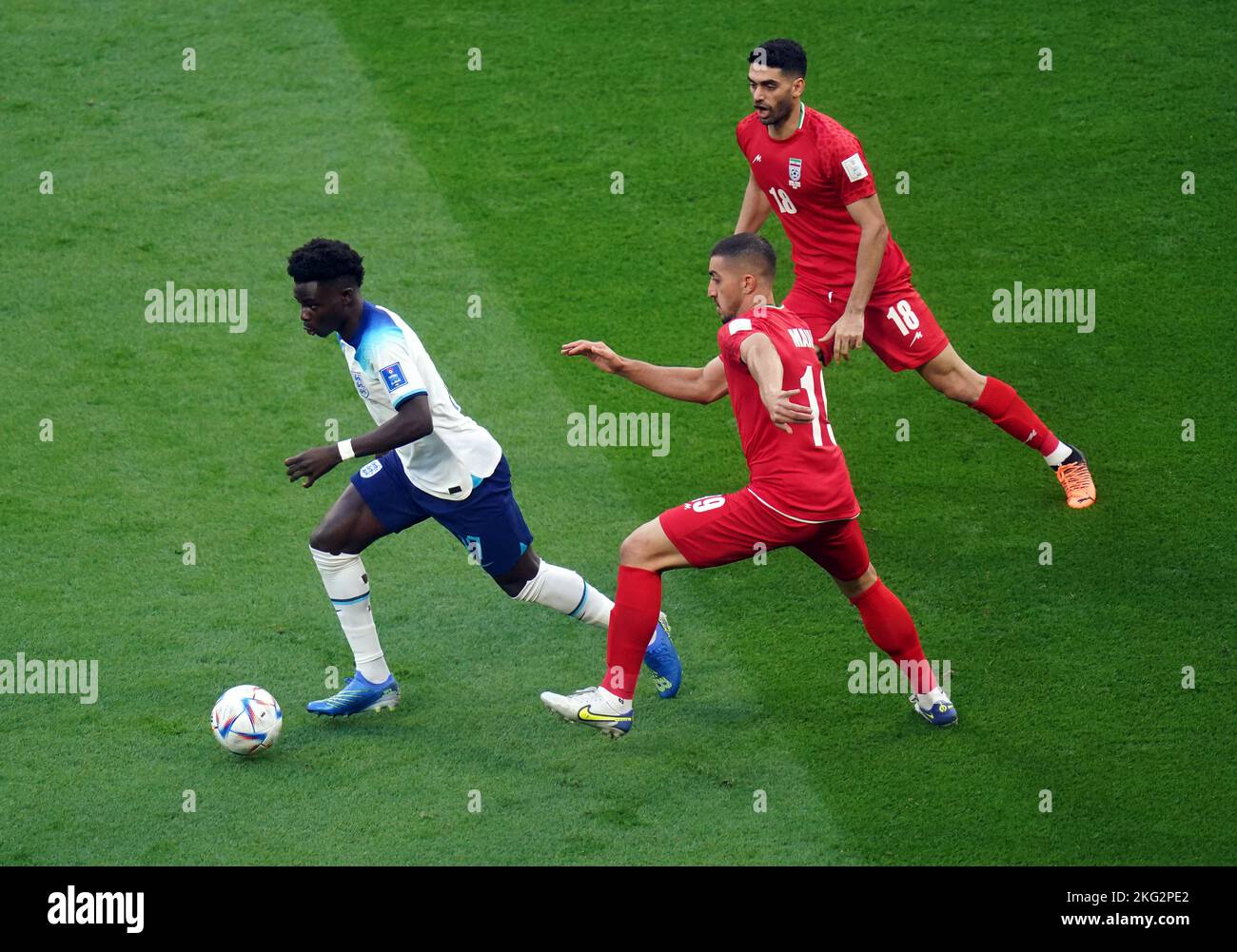 England's Bukayo Saka and Iran's Majid Hosseini (right) battle for the ball during the FIFA World Cup Group B match at the Khalifa International Stadium, Doha. Picture date: Monday November 21, 2022. Stock Photo