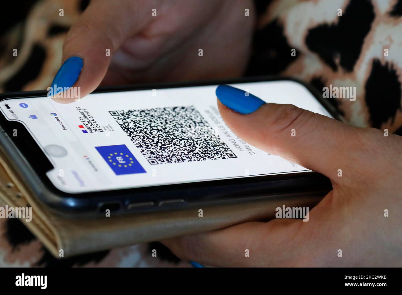 Woman looking a Covid pass with QR code on a smartphone. Close up on hands. Stock Photo