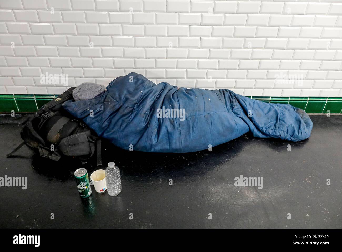 Homeless man sleeping in a subway corridor in Paris, France Stock Photo