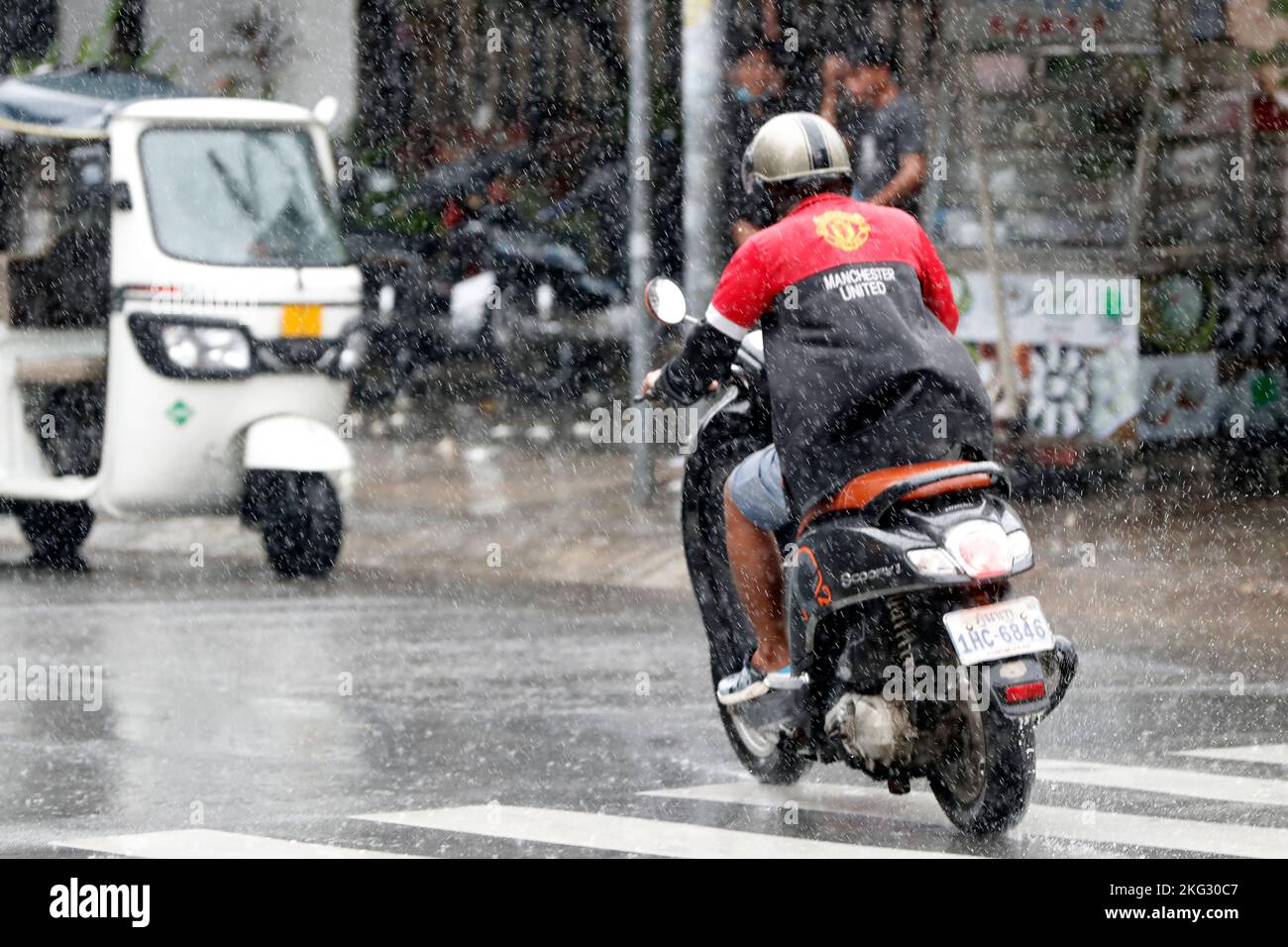 Scooter driver. Monsoon day in Phnom Penh. Phnom Penh. Cambodia Stock