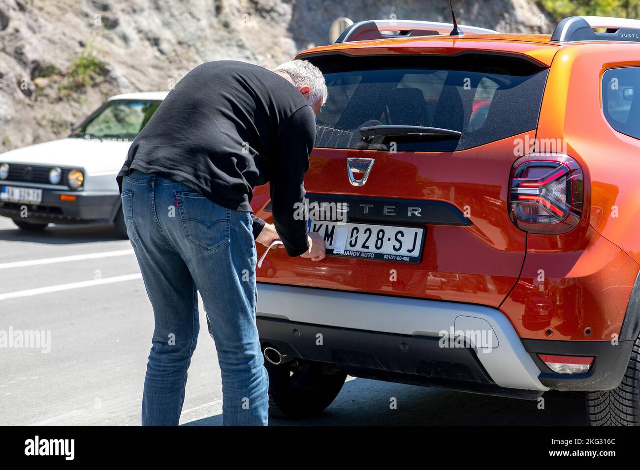 Serbia-Kosovo border crossing. Driver complying with number plate regulations. Stock Photo