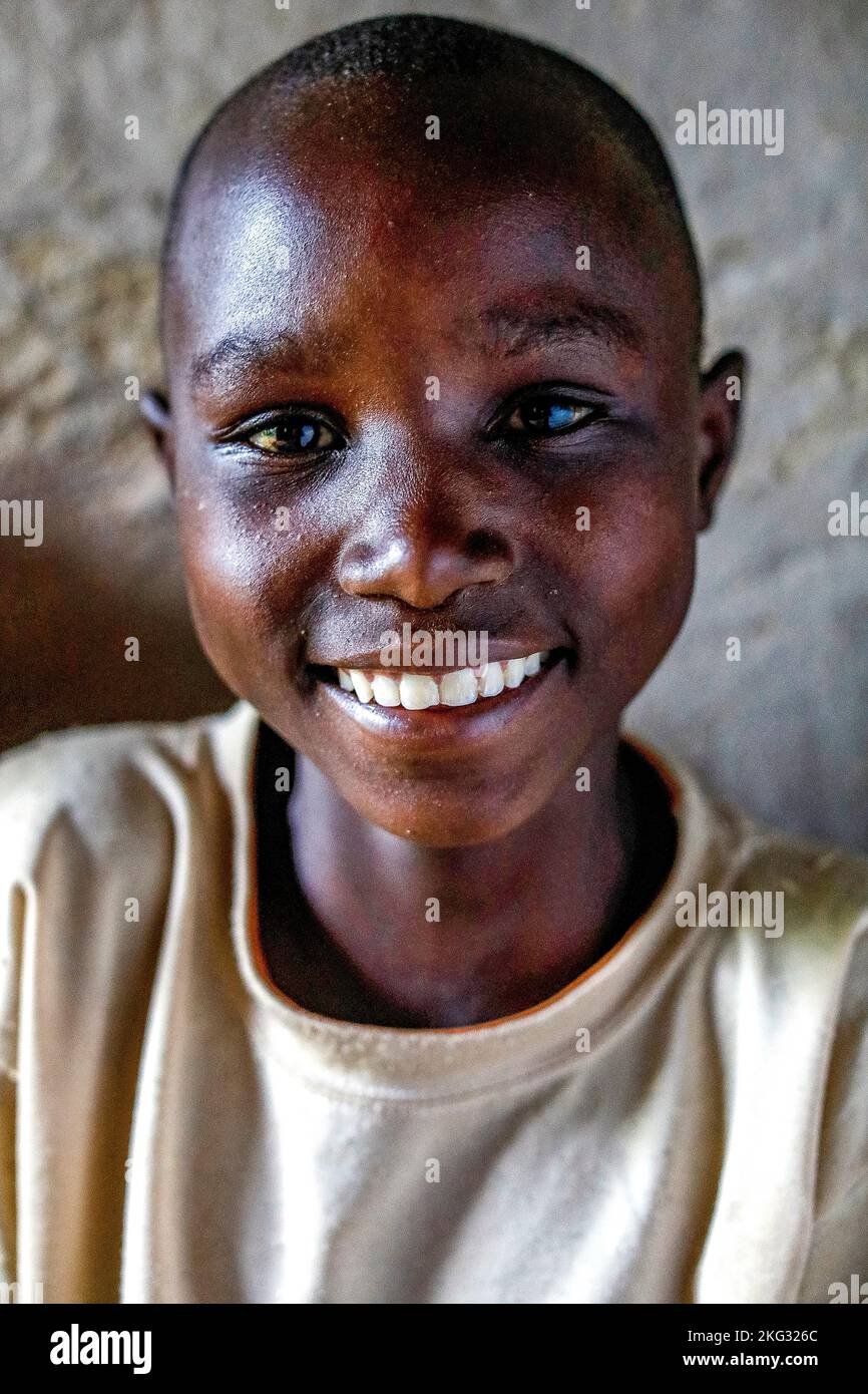 Smiling boy sitting in a home in southern Rwanda Stock Photo - Alamy