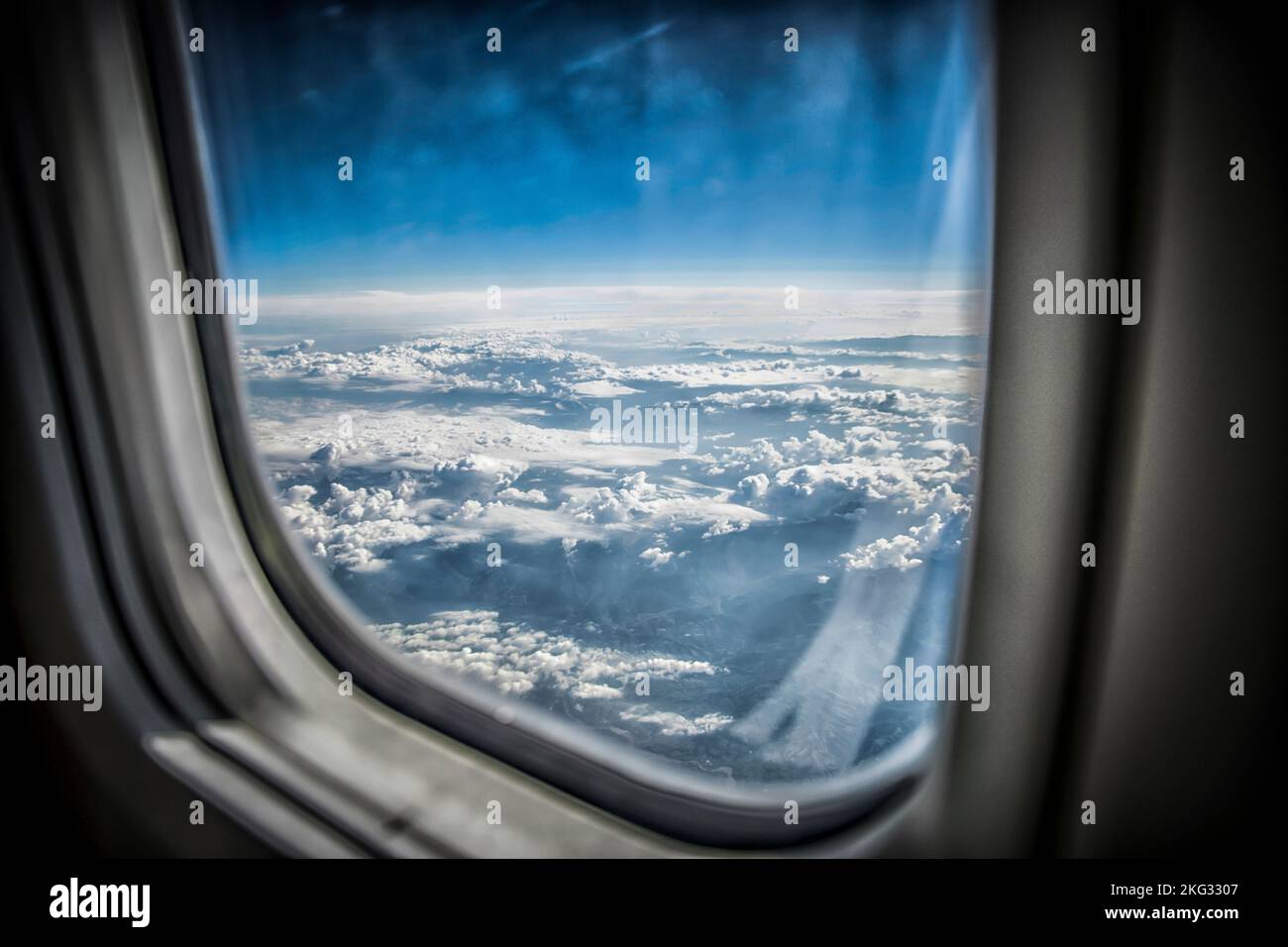 View of blue sky and fluffy clouds from an airplane window Stock Photo ...