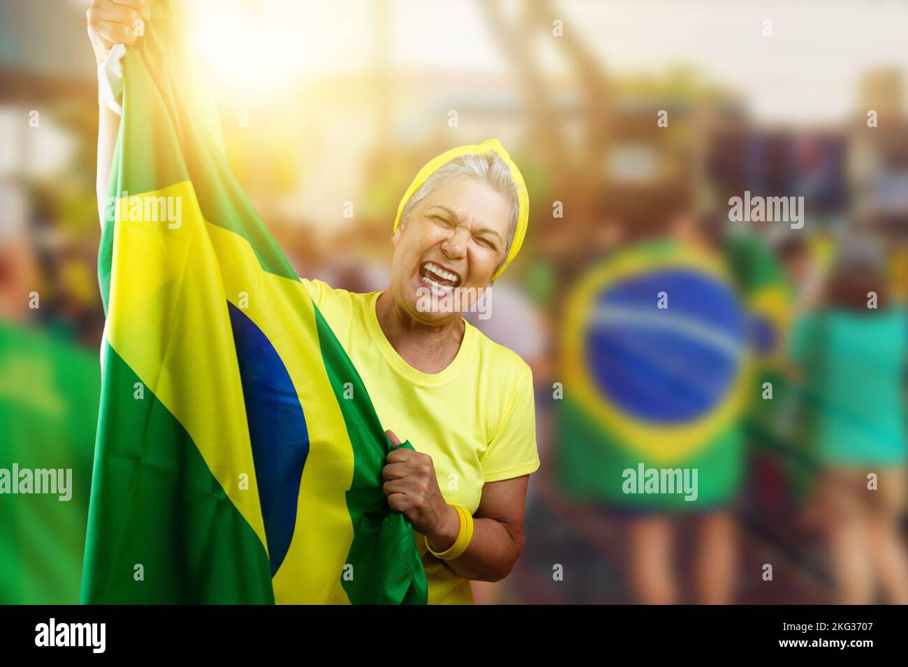 Senior Woman Holding Brazil Flag on Cinematic Background Written Towards Hex in Portuguese. For social media with copy space. Stock Photo