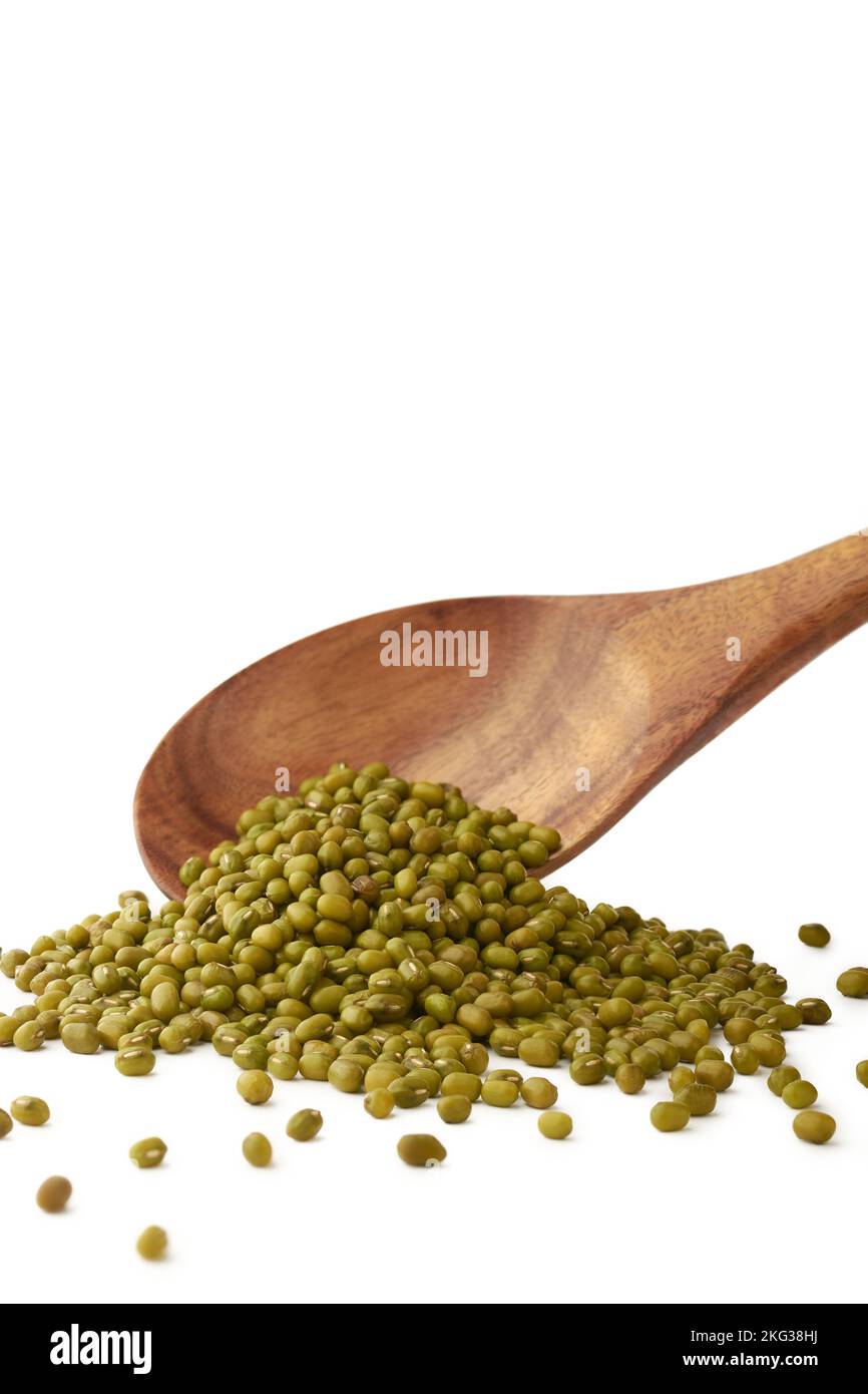 raw green gram or mung beans, high nutrients and antioxidant grain legumes falling from a wooden spoon, isolated on white background, selective focus Stock Photo