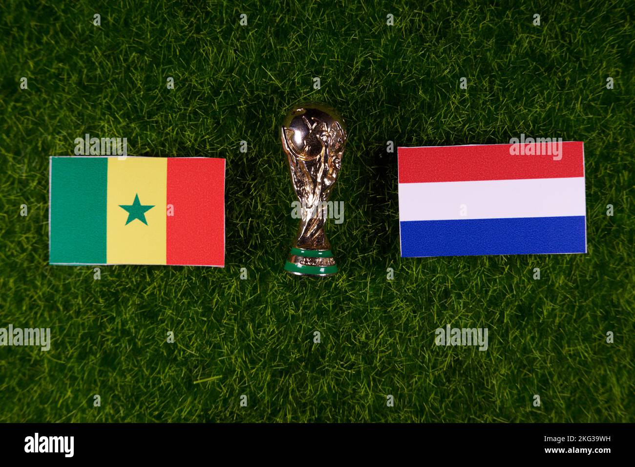 November 20, 2022, Doha, Qatar. Flags of Senegal and the Netherlands and the FIFA World Cup trophy on the green lawn of the stadium. Stock Photo