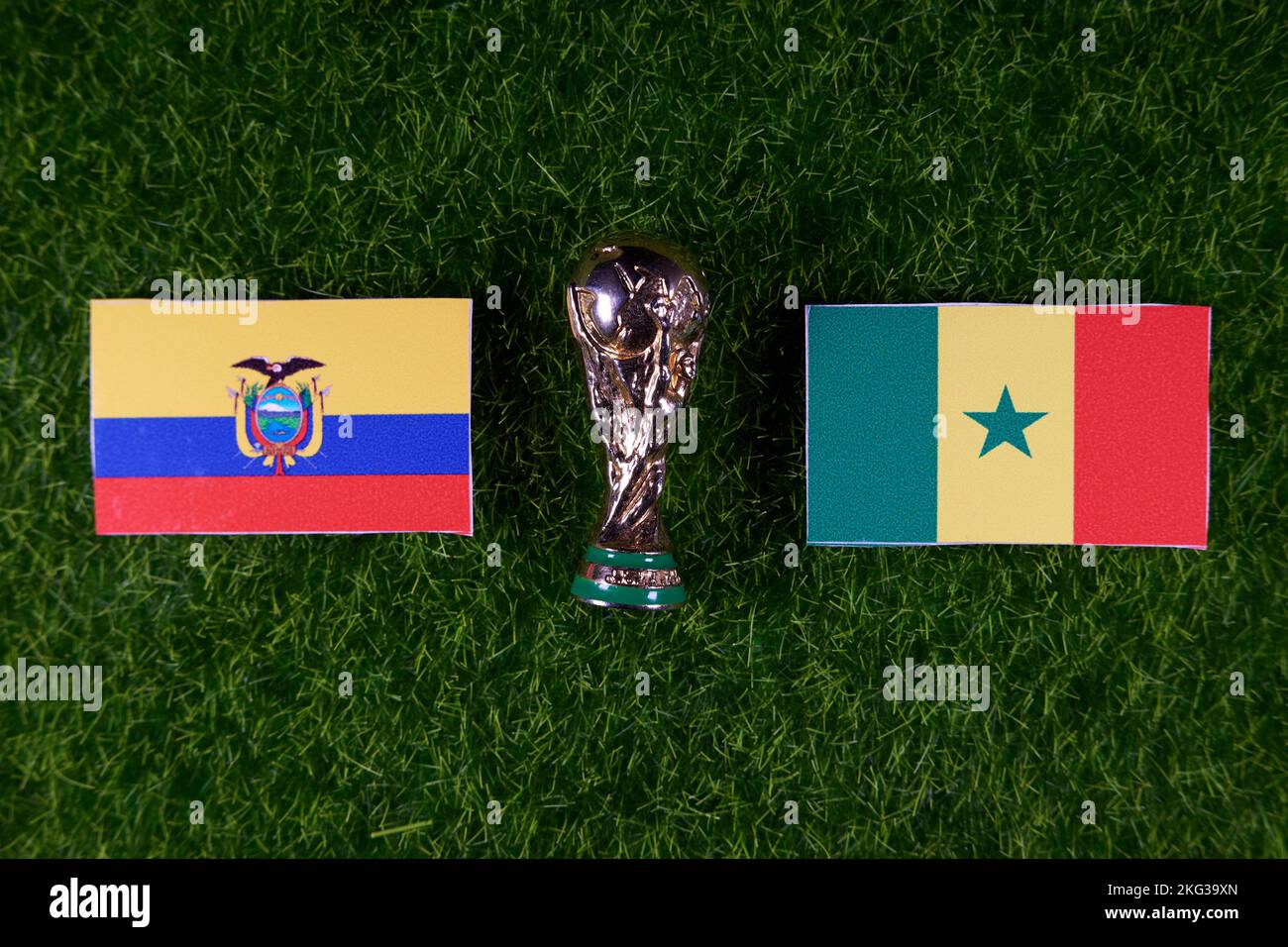 November 20, 2022, Doha, Qatar. Flags of Ecuador and Senegal and the FIFA World Cup trophy on the green lawn of the stadium. Stock Photo