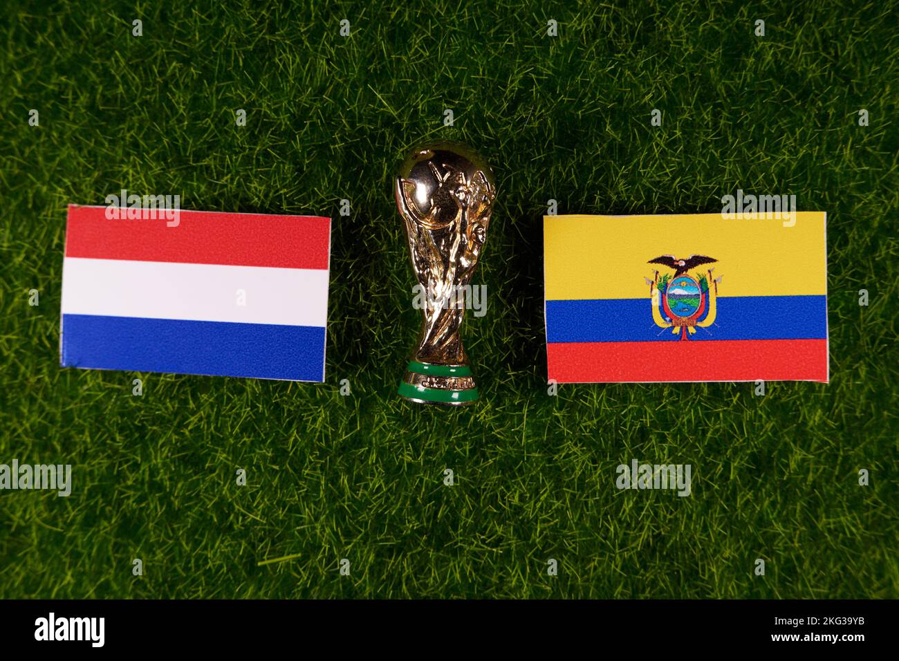 November 20, 2022, Doha, Qatar. Flags of Ecuador and the Netherlands and the FIFA World Cup trophy on the green lawn of the stadium. Stock Photo
