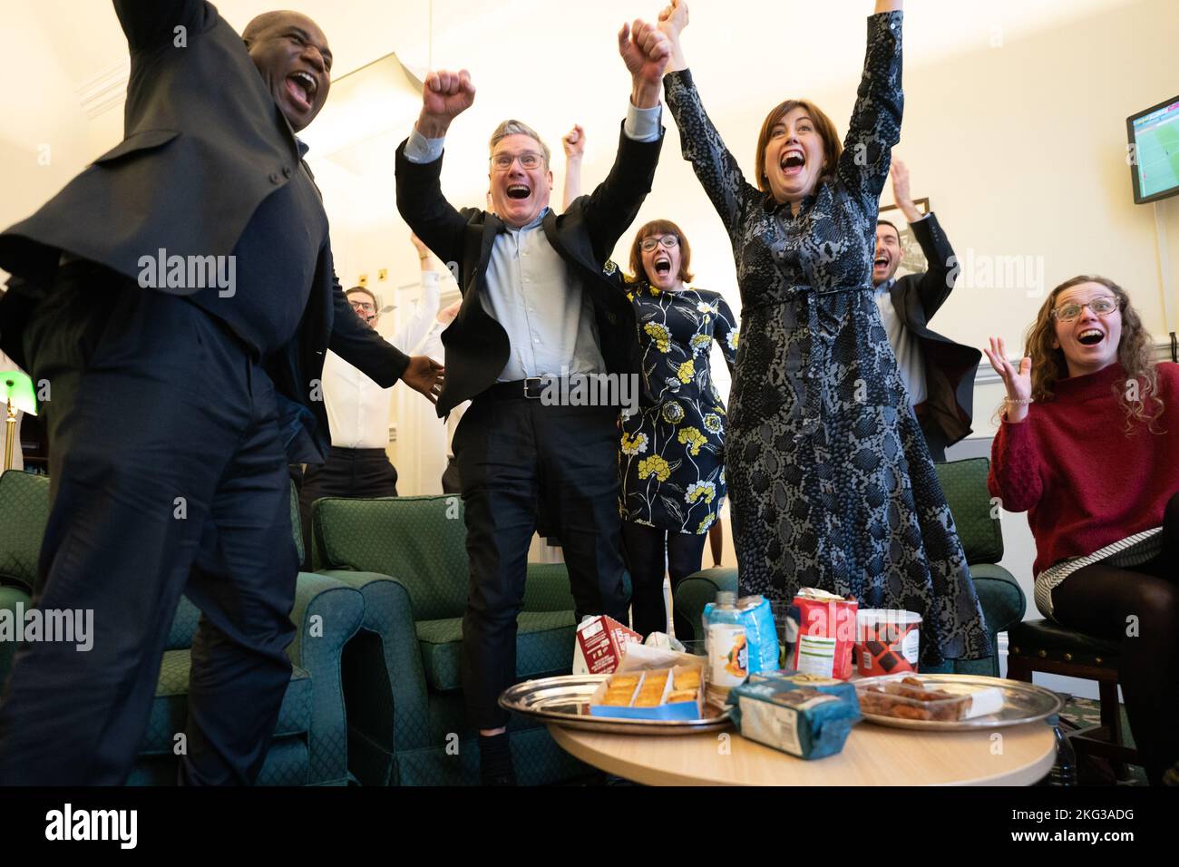 Labour leader Sir Keir Starmer (centre) celebrates England's second goal in their first round World Cup game against Iran with Shadow Foreign secretary David Lammy (left) and Shadow Culture Media & Sport secretary, Lucy Powell (right) in his office in the House Of Parliament in London during the FIFA World Cup 2022. Picture date: Monday November 21, 2022. Stock Photo
