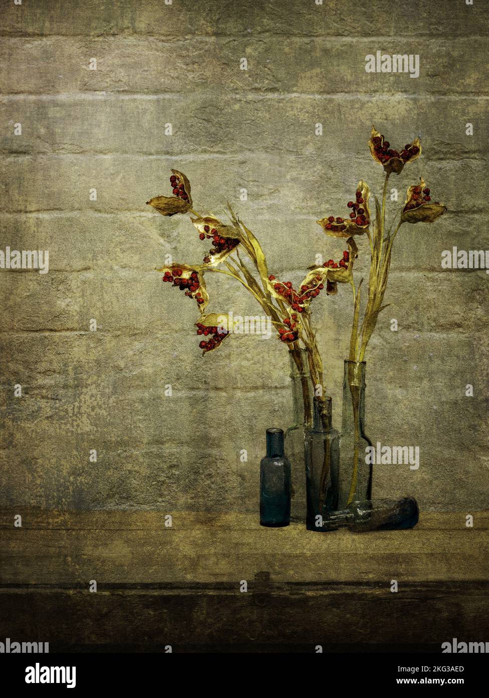 Wabi sabi still life with old bottles and dried stinking iris seed heads. Rustic interior. Stock Photo
