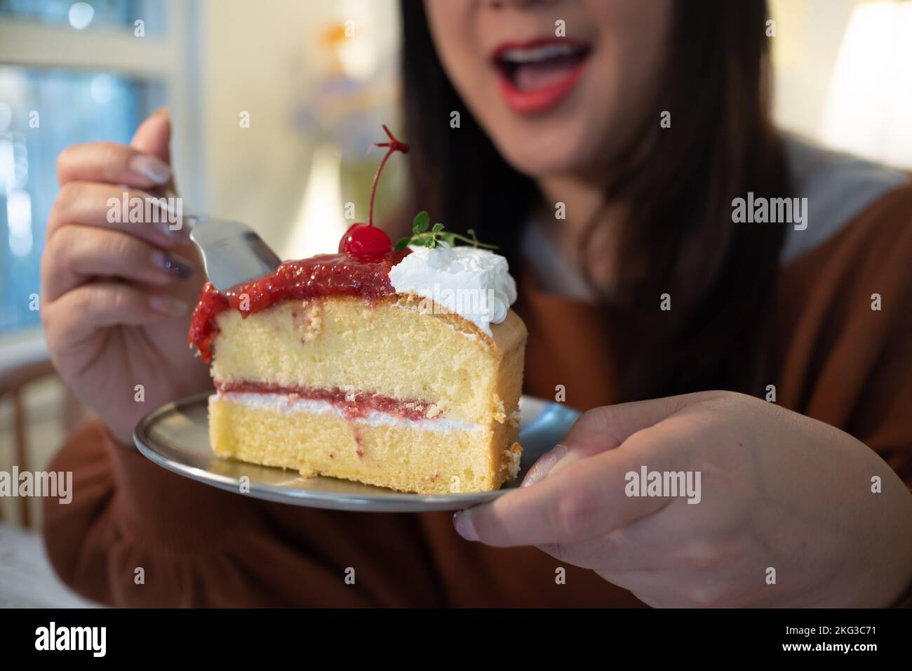 Women eating cake at home with happy face expression Stock Photo Alamy