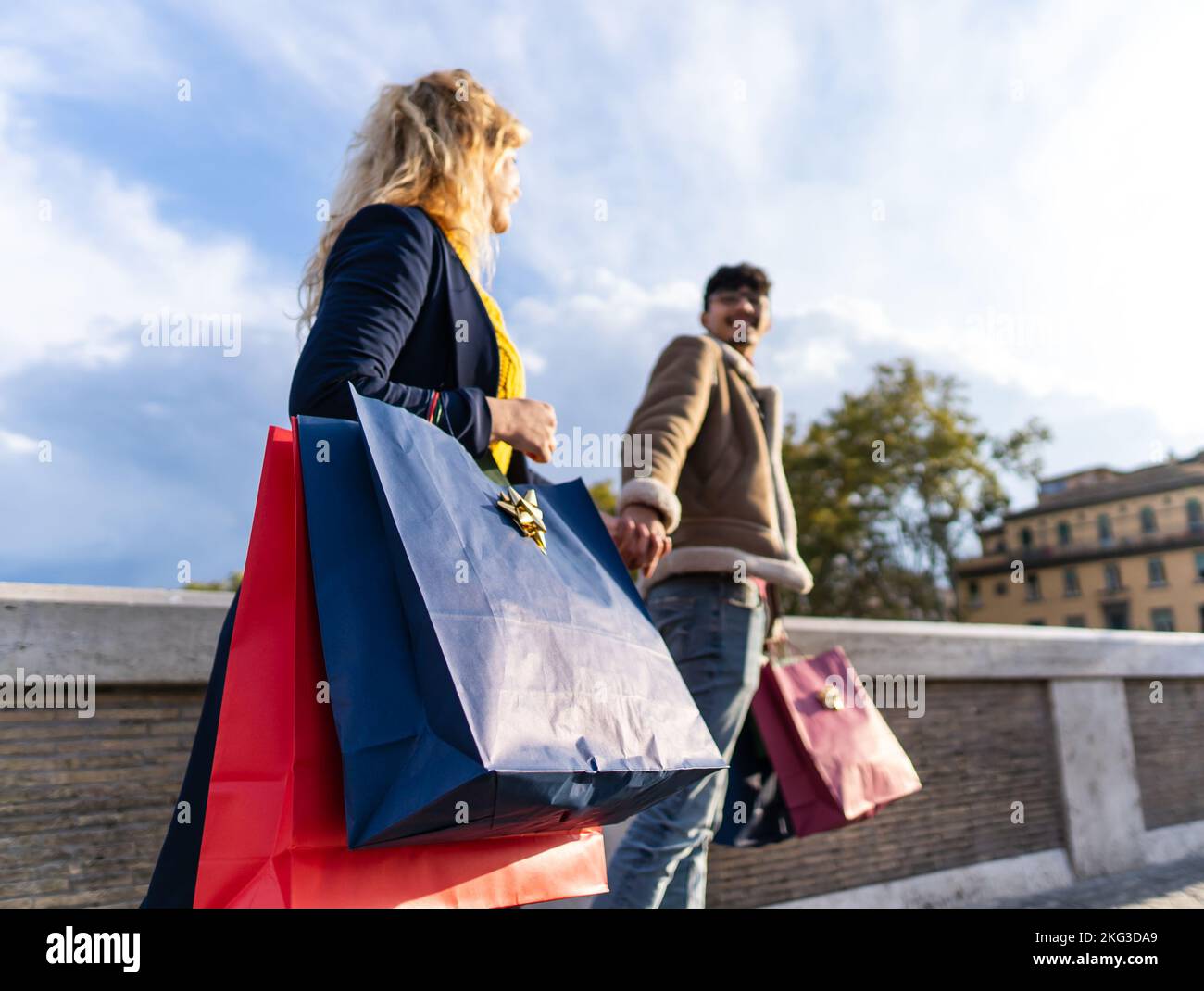 selective focus on shopping bags of Young couple walking in the city with shopping bags, shopping time Stock Photo