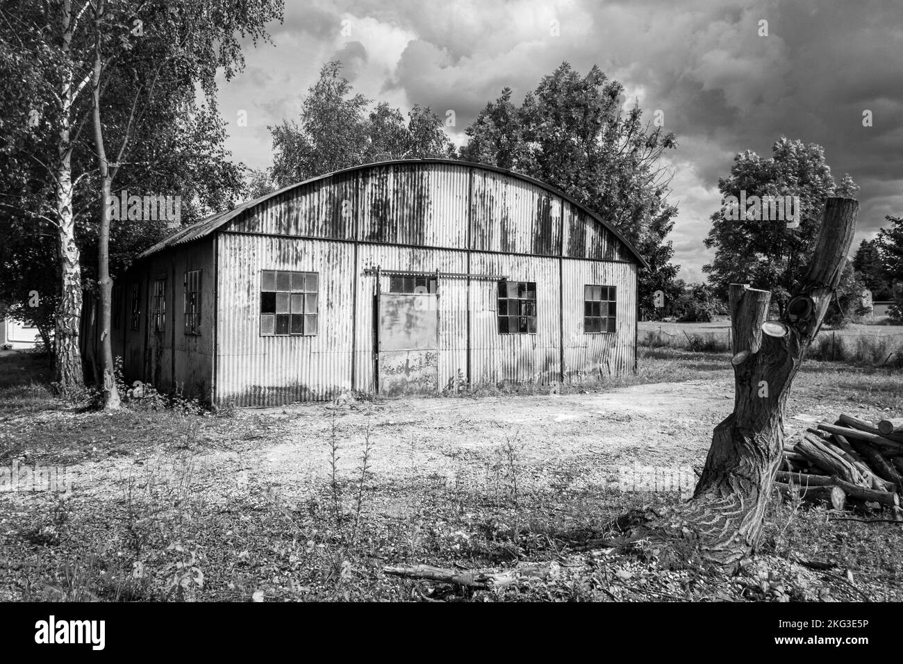 An abandoned warehouse in Germany, grayscale shot Stock Photo