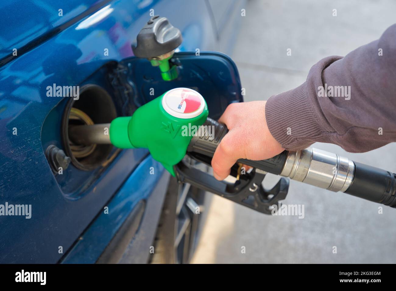 filling up a car's petrol tank at a gas station Stock Photo