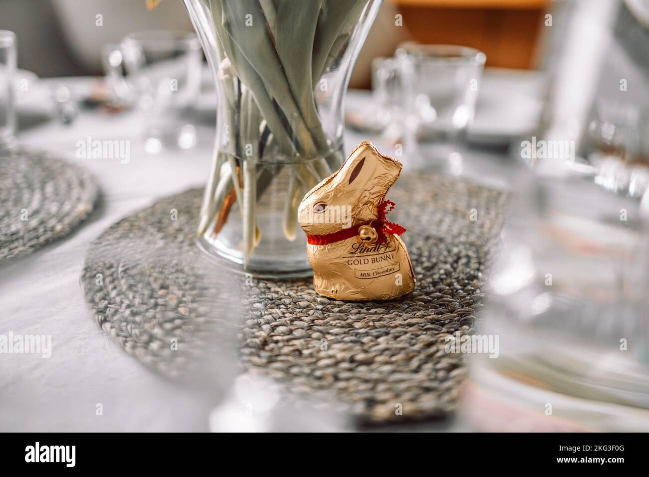18 April 2022 Krakow, Poland: Happy Easter holiday. Golden chocolate Lindt Easter Rabbit on white table background. Easter banner. Stock Photo