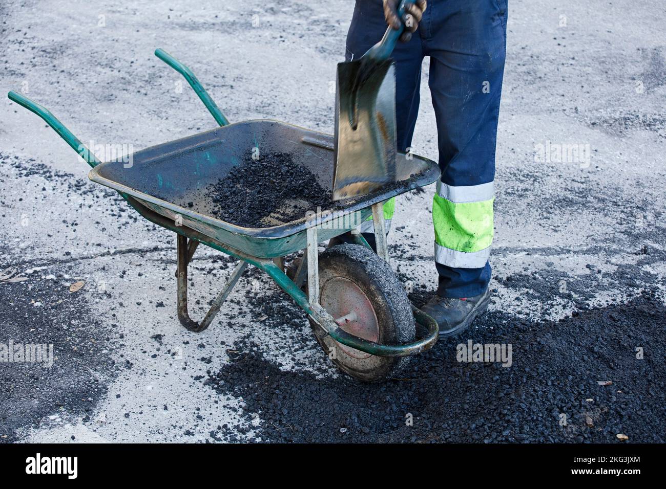 asphalt in wheelbarrow operator prepares mixture with uniform Stock ...