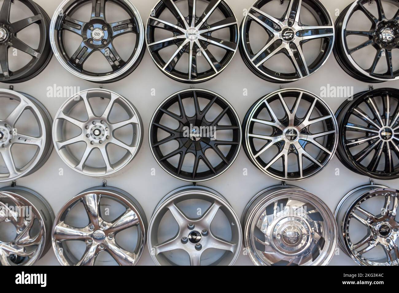 The view of different types of vehicle rims on the white wall Stock