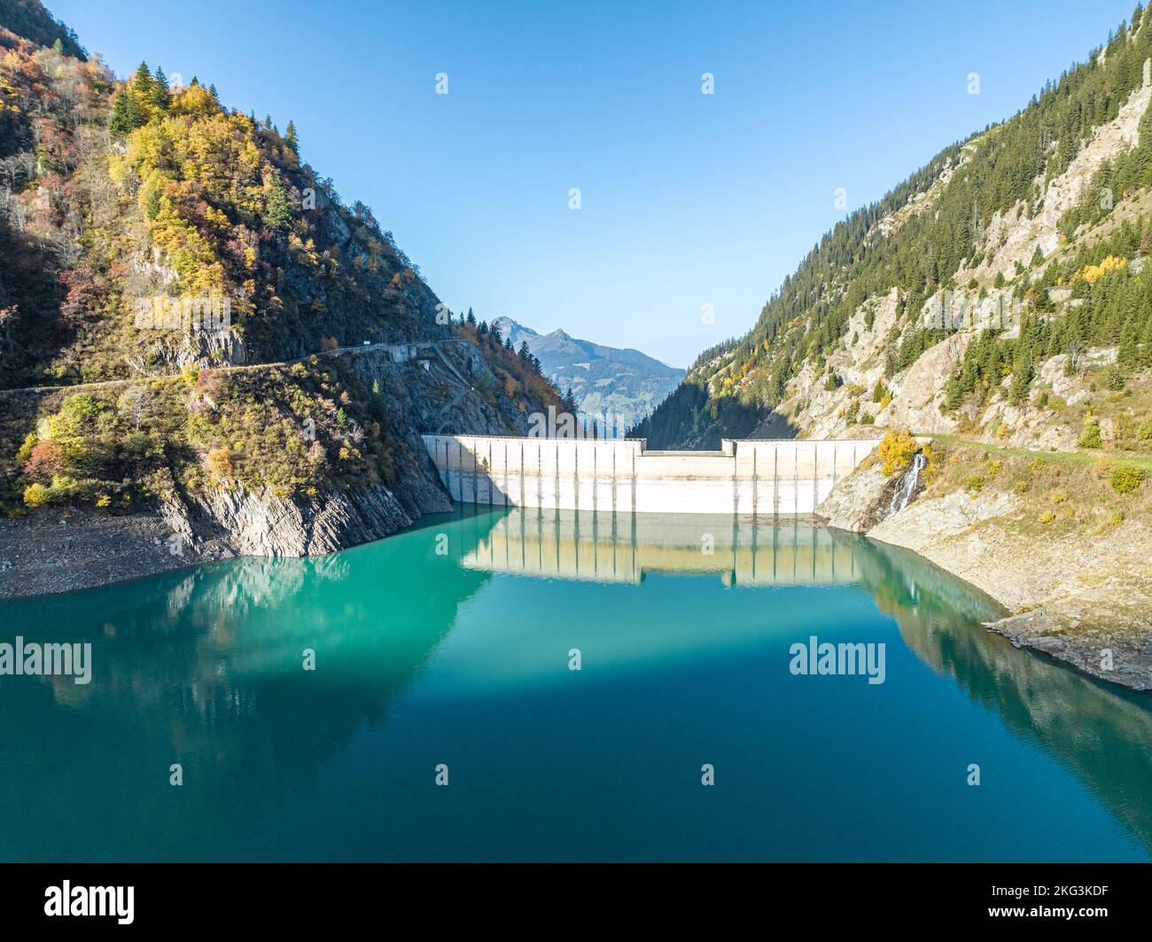 aerial perspective shot of still water blocked by walls of dam on