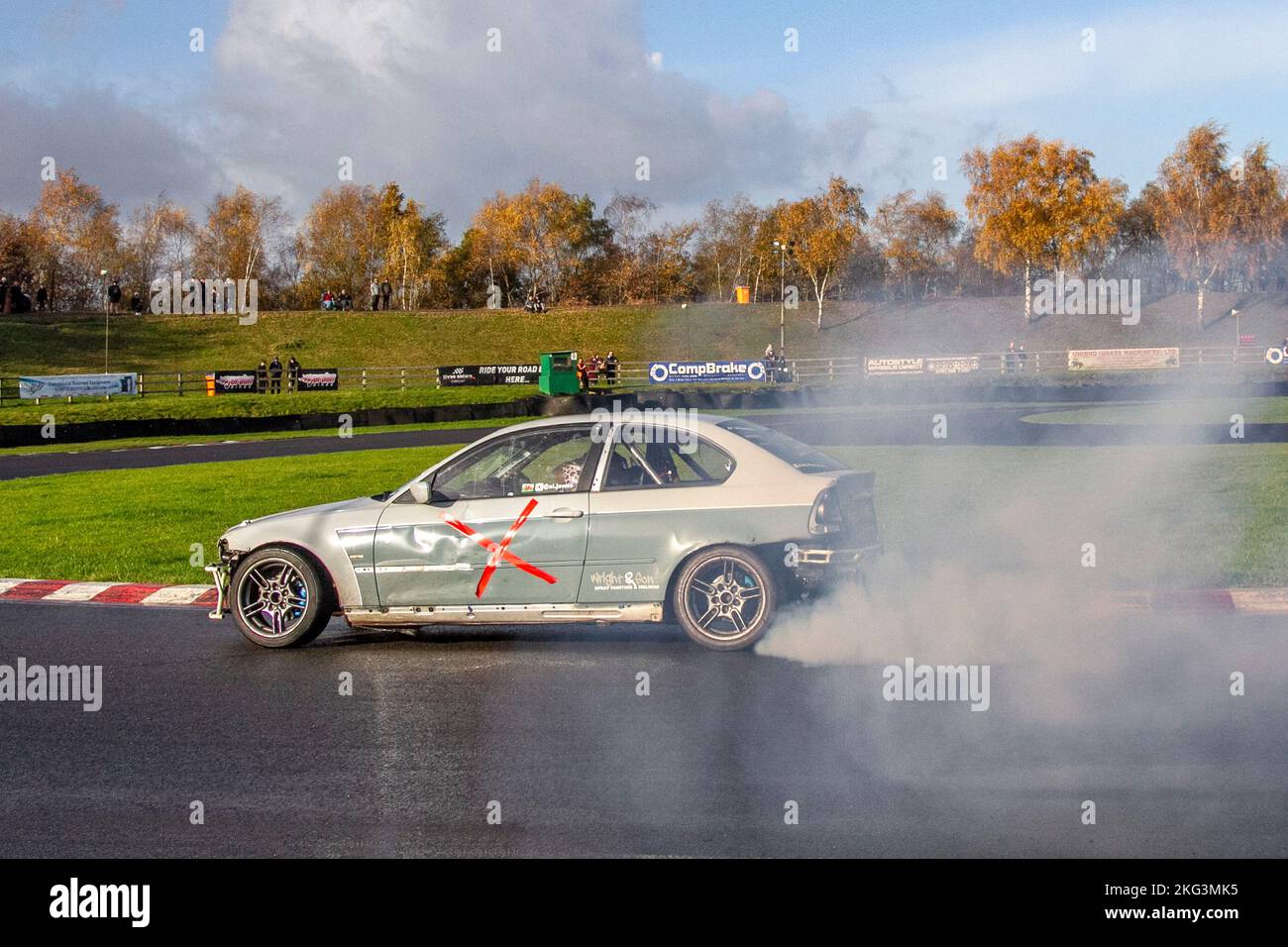 Grey white modified BMW 3 Series; HYC custom motorsport; Rear-wheel-drive car, driving on drift tracks and high-speed cornering on wet roads on a Three Sisters Drift Day in Wigan, UK Stock Photo