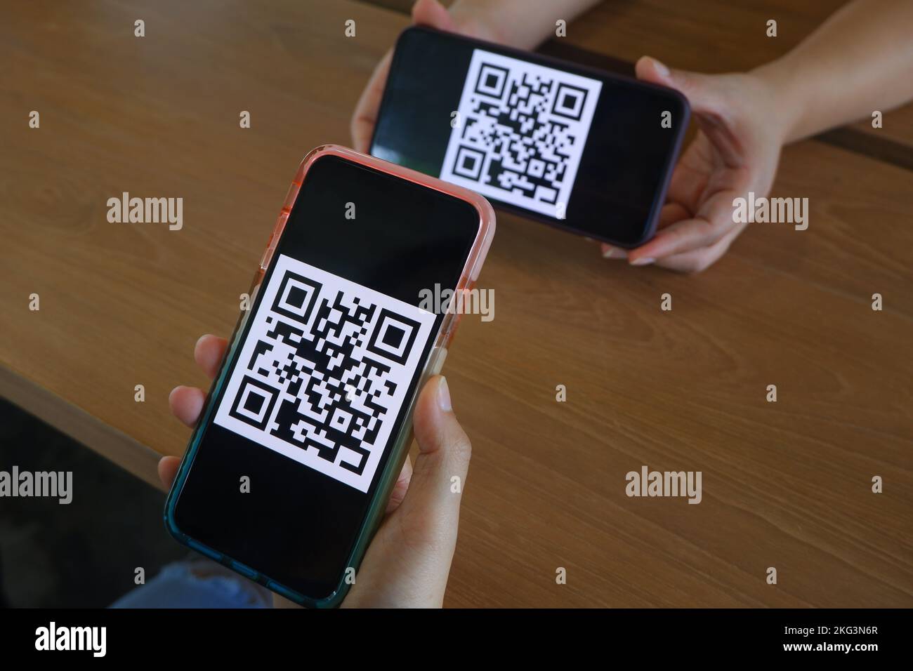 Women's hand uses a mobile phone application to scan QR codes in stores