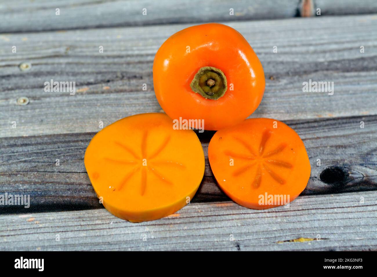 The persimmon is the edible fruit of a number of species of trees in