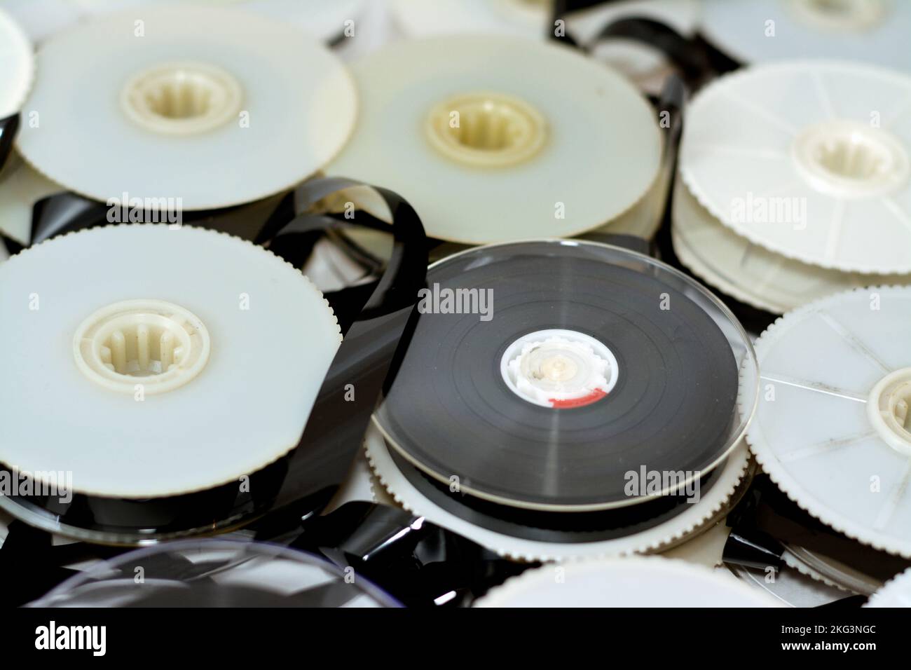 Stack of supply and take up reels with ribbon of VHS video cassette