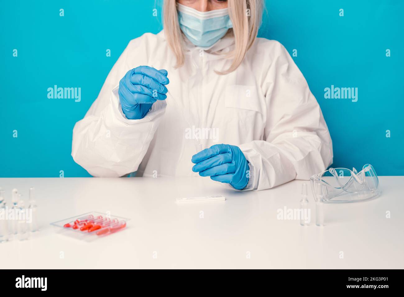 A laboratory employee taking sample PCR microtubes with cotton swab test. Diagnostic testing for