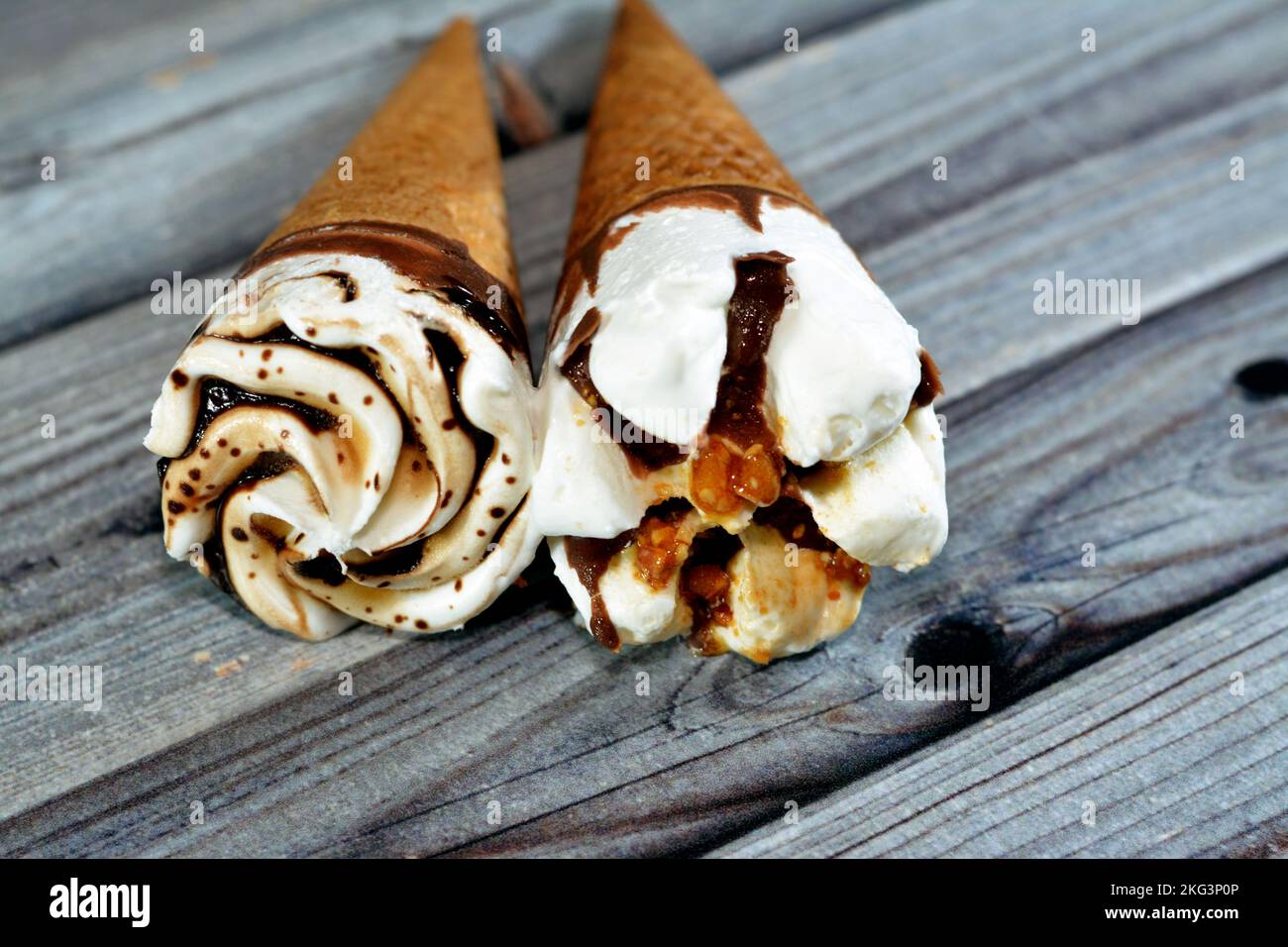 Ice cream vanilla cones with topping of chocolate and caramel sauce and