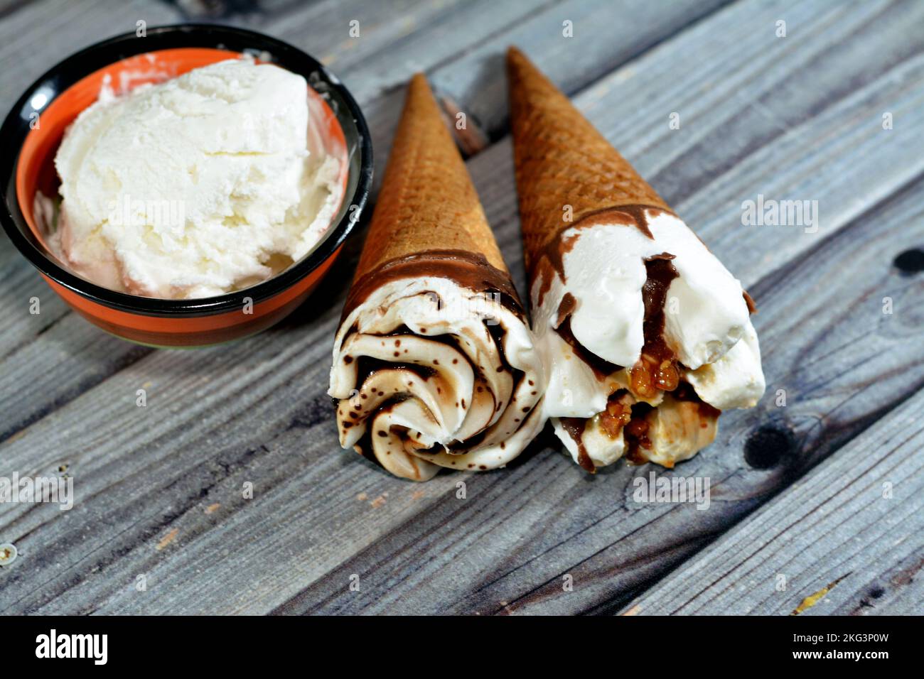 Ice cream vanilla cones with topping of chocolate and caramel sauce and