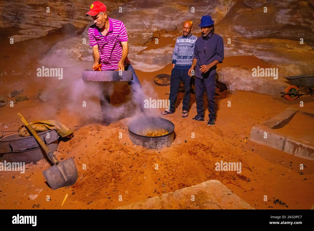 Bedouin cooking demonstration using an underground oven. Stock Photo