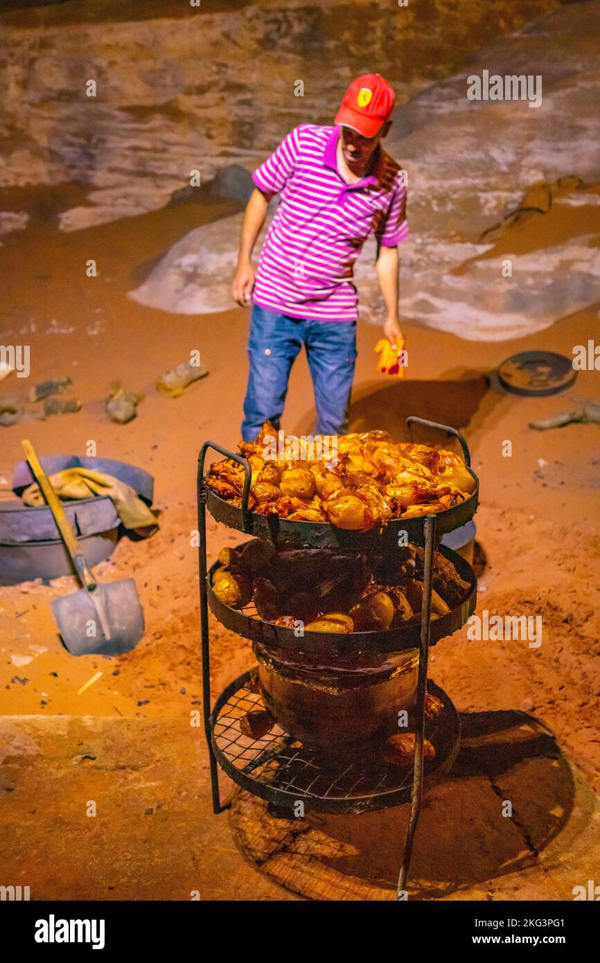 Bedouin cooking demonstration using an underground oven. Stock Photo