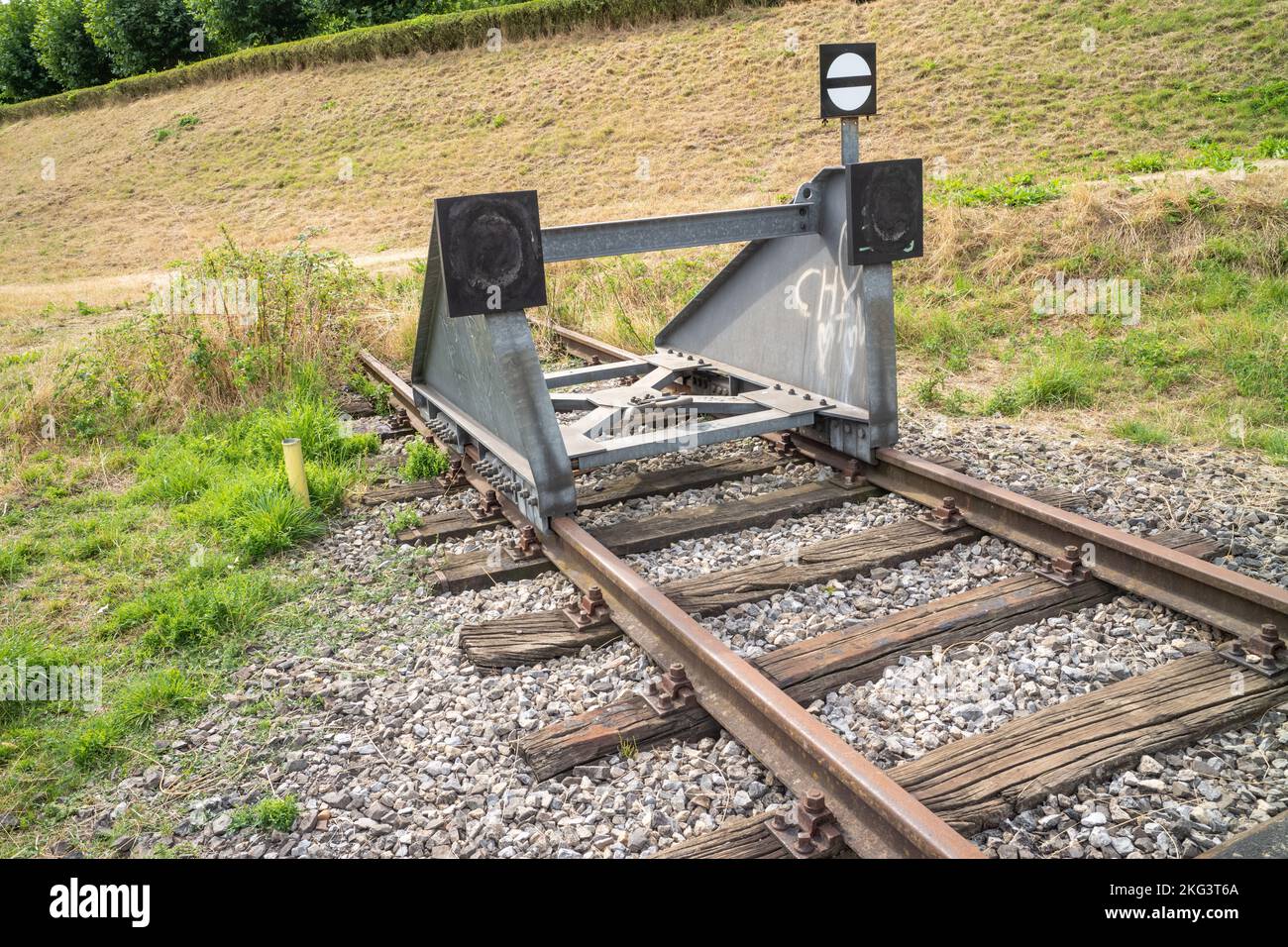 A buffer stop of a railroad in the field Stock Photo
