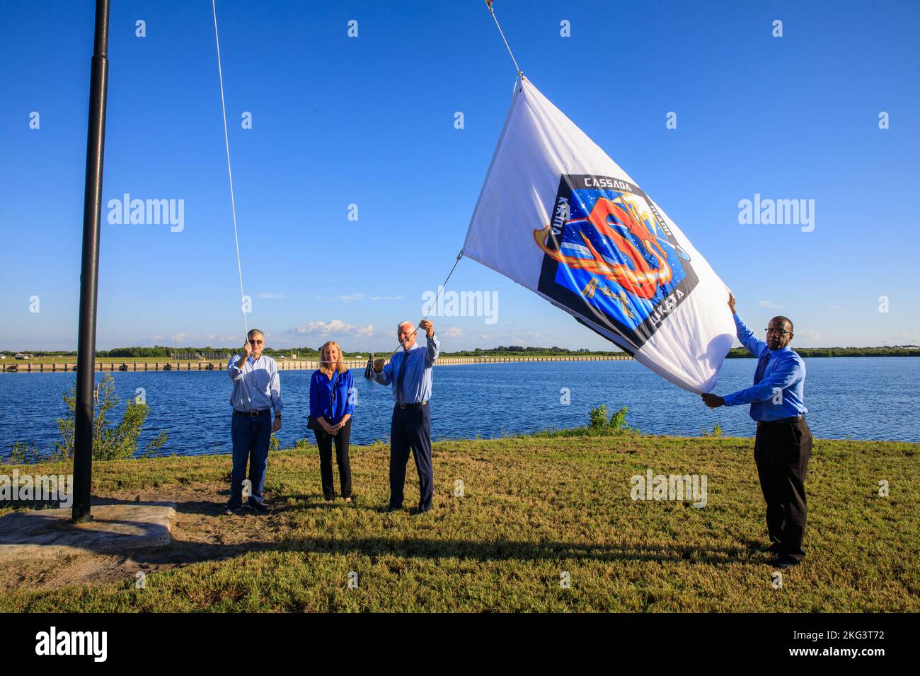 SpaceX Crew-5 Flag Raising. NASA Commercial Crew Program (CCP) employees Tyrell Hawkins (right) and Henry May (second from right) raise the Crew-5 flag near the countdown clock at the Press Site at NASA’s Kennedy Space Center in Florida on Oct. 3, 2022. Next to May is his wife, and to the left is CCP Manager Steve Stich. NASA’s SpaceX Crew-5 mission will carry NASA astronauts Josh Cassada and Nicole Aunapu Mann, Roscosmos cosmonaut Anna Kikina, and JAXA (Japan Aerospace Exploration Agency) to the International Space Station for a science expedition mission as part of the agency’s CCP. SpaceX’s Stock Photo