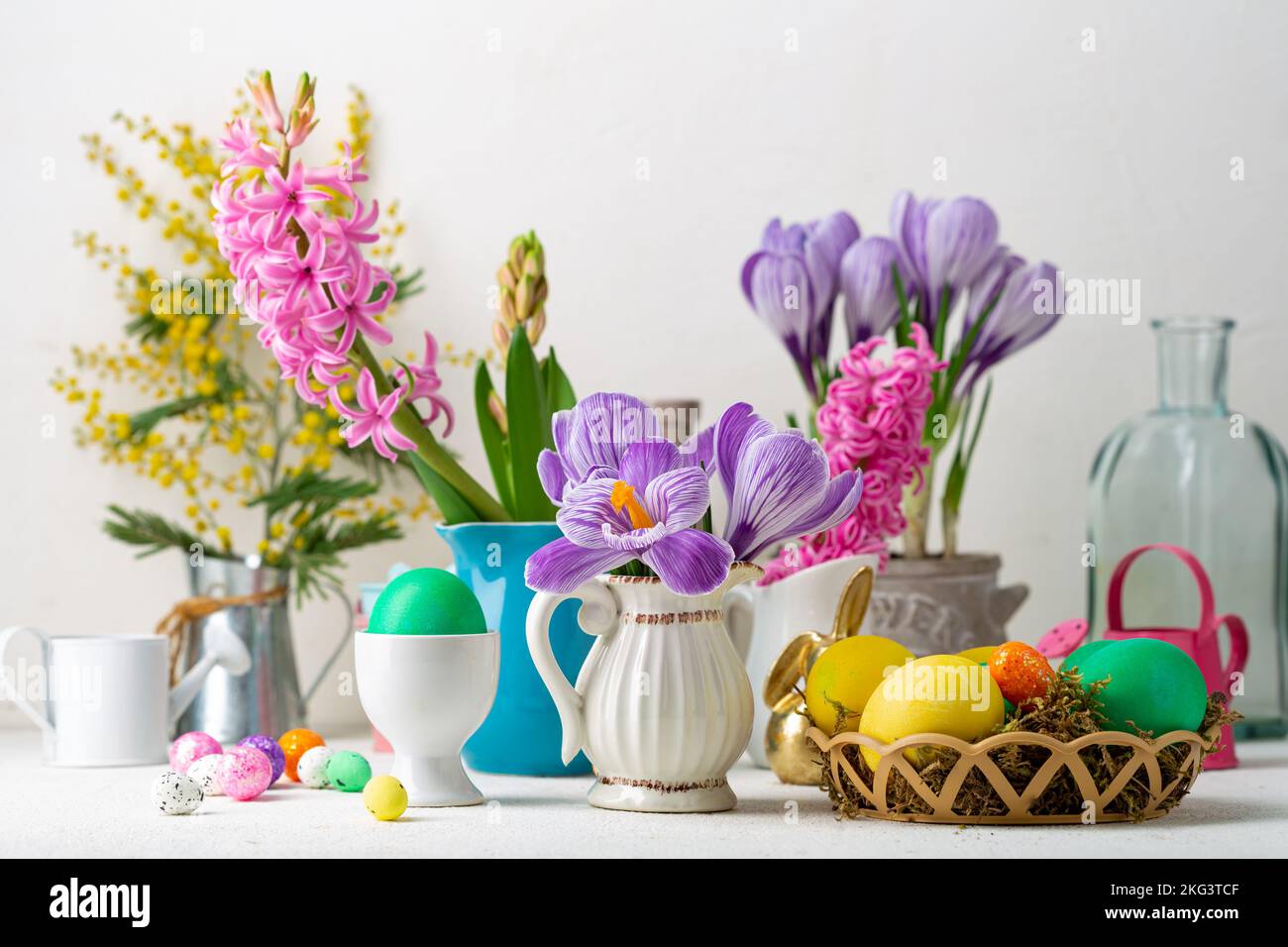 Spring flowers in pot and pitcher Easter background Stock Photo