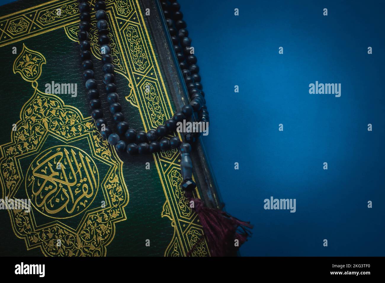 Holy Quran with Arabic calligraphy meaning of Al Quran and tasbih or