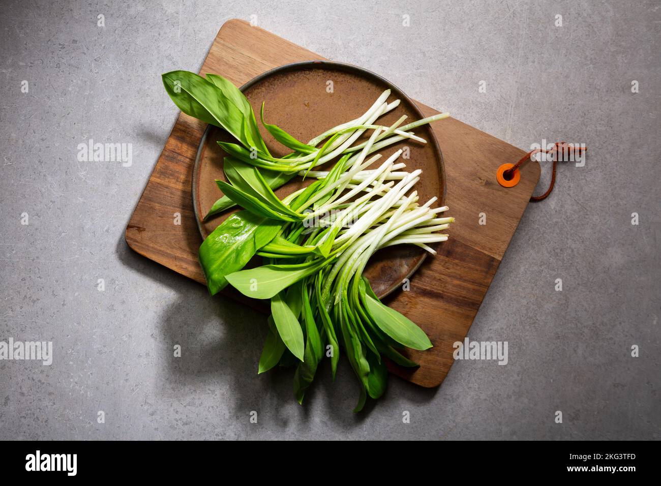 Edible wild garlic leek on kitchen board food Stock Photo