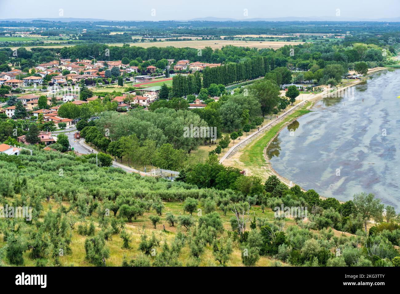 Aerial view looking down on the shore of Lake Trasimeno from the historic old town of Castiglione del Lago, Province of Perugia, Umbria, Italy Stock Photo