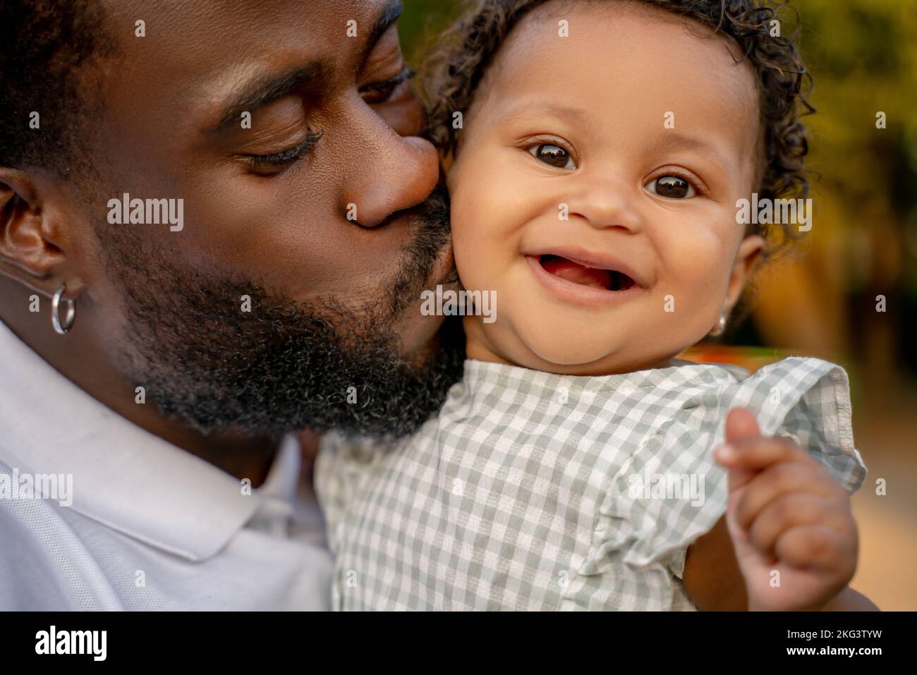 Loving dad giving a kiss to his petty child Stock Photo