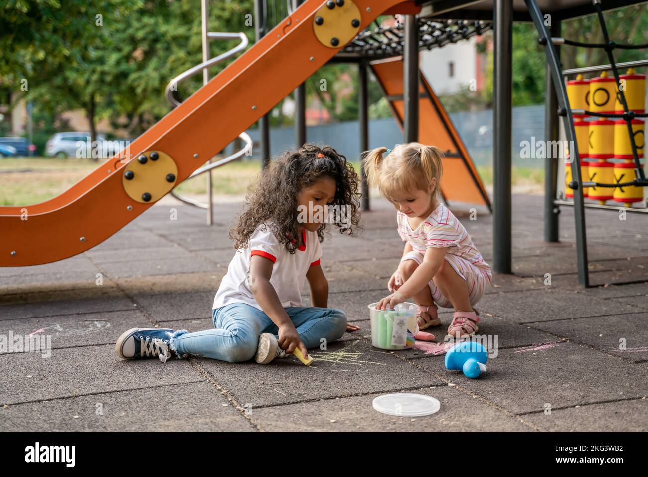 Two kids involved in a creative outdoor activity Stock Photo