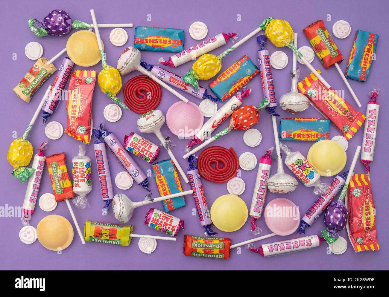 DEVON, ENGLAND - NOVEMBER 6 2022: Flat lay still life of retro children's sweets. Love Hearts, lollipops etc. Stock Photo